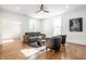 Spacious living room with hardwood floors, a ceiling fan, and large windows at 1034 N Tacoma Ave, Indianapolis, IN 46201