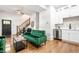 Open-concept living space with wood floors and a charming green velvet sofa at 1034 N Tacoma Ave, Indianapolis, IN 46201