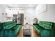 Open-concept living space with hardwood floors, white cabinets, and stainless steel appliances at 1034 N Tacoma Ave, Indianapolis, IN 46201