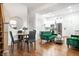 Open-concept living and dining space with hardwood floors and a round dining table at 1034 N Tacoma Ave, Indianapolis, IN 46201