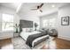 Serene bedroom with a tufted headboard, ceiling fan, and lots of natural light at 1034 N Tacoma Ave, Indianapolis, IN 46201