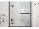 Shower enclosed with glass, showcasing white marble walls and modern black hardware at 1034 N Tacoma Ave, Indianapolis, IN 46201