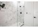 Modern walk-in shower featuring marble tile, a glass door, and a rainfall shower head at 1034 N Tacoma Ave, Indianapolis, IN 46201