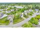 An aerial view of the neighborhood shows mature trees and manicured lawns surrounding well-maintained homes at 10717 Morristown Ct, Carmel, IN 46032