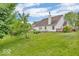 Manicured backyard with lush green grass, mature trees, and a view of the house at 10717 Morristown Ct, Carmel, IN 46032