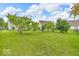 A view of the green, well-manicured backyard with shade trees at 10717 Morristown Ct, Carmel, IN 46032