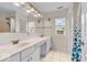 Bathroom with a double vanity, well-lit mirror, and shower at 10717 Morristown Ct, Carmel, IN 46032