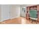 Bedroom with hardwood floors, bright window, and wooden desk with green chair at 10717 Morristown Ct, Carmel, IN 46032