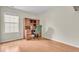 Bedroom with hardwood floors, large window, and wooden desk with chair at 10717 Morristown Ct, Carmel, IN 46032