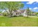 Beautiful two-story house featuring a covered porch, a manicured lawn, and mature trees, creating a serene and inviting atmosphere at 10717 Morristown Ct, Carmel, IN 46032