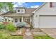 Attractive two-story home featuring a welcoming front porch, two-car garage, and well-maintained landscaping at 10717 Morristown Ct, Carmel, IN 46032