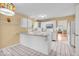 Bright eat-in kitchen with white cabinets and view of the living room at 10717 Morristown Ct, Carmel, IN 46032
