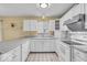 Well-lit kitchen with white appliances and a granite countertop at 10717 Morristown Ct, Carmel, IN 46032