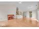 Open-concept living room with wood floors, staircase, and ample natural light, perfect for entertaining and relaxation at 10717 Morristown Ct, Carmel, IN 46032