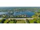 Aerial view showcases a serene community nestled around a picturesque lake at 11065 Spice Ln, Fishers, IN 46037