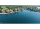 Aerial view showcases the home's waterfront location with boat docks, mature trees, and manicured lawns at 11065 Spice Ln, Fishers, IN 46037