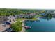 Aerial view of property with boat docks, lush landscaping, and the serene waterfront, surrounded by community at 11065 Spice Ln, Fishers, IN 46037