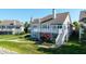 Backyard view highlights the multi-level deck, landscaped garden, and access to a beautifully maintained lawn at 11065 Spice Ln, Fishers, IN 46037