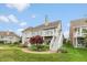 Backyard view highlighting the multi-level deck, landscaped garden, and access to a beautifully maintained lawn at 11065 Spice Ln, Fishers, IN 46037