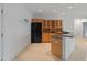 Open basement area with bar, cabinetry, and refrigerator at 11065 Spice Ln, Fishers, IN 46037