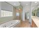 Bathroom boasts soaking tub, glass-enclosed shower and ample natural light at 11065 Spice Ln, Fishers, IN 46037