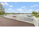 Spacious wooden deck with white railing, offering scenic views of the tranquil lake at 11065 Spice Ln, Fishers, IN 46037