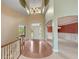 Grand entrance hall featuring hardwood floors, a chandelier, and arched doorways at 11065 Spice Ln, Fishers, IN 46037