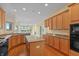 Modern kitchen featuring an island with seating, hardwood floors, and stainless-steel appliances at 11065 Spice Ln, Fishers, IN 46037