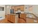 This kitchen features stainless steel appliances, granite counters, and hardwood floors at 11065 Spice Ln, Fishers, IN 46037