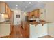 Bright open kitchen with granite countertops, wood floors, and stainless steel appliances at 11065 Spice Ln, Fishers, IN 46037