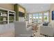 Inviting living room with built-in shelves, a fireplace, and large windows offering scenic views at 11065 Spice Ln, Fishers, IN 46037