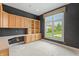 Bright office features built-in cabinets, a spacious desk area, and a large window overlooking the yard at 11065 Spice Ln, Fishers, IN 46037