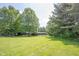 Lush backyard with mature trees and a well-maintained lawn, providing ample space for recreation and enjoyment at 11423 Atlantic Rd, Fortville, IN 46040