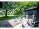 Backyard patio area featuring modern seating, a fire pit, and view of the lawn at 11423 Atlantic Rd, Fortville, IN 46040