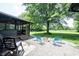 Charming backyard featuring a firepit, comfortable seating, and a hammock between the trees at 11423 Atlantic Rd, Fortville, IN 46040