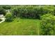 Expansive backyard featuring well-maintained grass, complemented by a backdrop of lush, mature trees at 11423 Atlantic Rd, Fortville, IN 46040