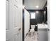 Modern bathroom featuring dark walls and contrasting white marble floors and vanity at 11423 Atlantic Rd, Fortville, IN 46040