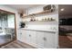 Elegant dining area with custom cabinetry, open shelves, and stylish decor, creating a perfect space for entertaining and everyday living at 11423 Atlantic Rd, Fortville, IN 46040
