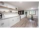 Elegant dining area adjacent to a stylish living space features custom cabinetry, shelving, and modern decor, perfect for entertaining at 11423 Atlantic Rd, Fortville, IN 46040