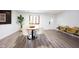 Clean dining space with wood-look floors, a round table and large windows at 11423 Atlantic Rd, Fortville, IN 46040