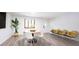 Clean dining space with wood-look floors, a round table and large windows at 11423 Atlantic Rd, Fortville, IN 46040