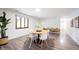 Well-lit dining space with wood-look floors, a round table and a large plant at 11423 Atlantic Rd, Fortville, IN 46040