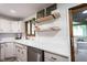 Bright kitchen featuring a marble countertop, undermount sink, floating shelves, and stainless steel dishwasher at 11423 Atlantic Rd, Fortville, IN 46040