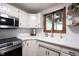 Bright kitchen with a window above the sink, stainless steel microwave and range at 11423 Atlantic Rd, Fortville, IN 46040