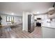 Bright, open kitchen with stainless steel appliances and sleek countertops leading to dining area at 11423 Atlantic Rd, Fortville, IN 46040