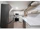 Bright kitchen with stainless steel appliances, white cabinets, and open shelving for stylish storage at 11423 Atlantic Rd, Fortville, IN 46040