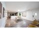 Open-concept living room and dining area with hardwood floors, neutral paint, and a view of the backyard at 11423 Atlantic Rd, Fortville, IN 46040