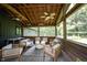 Comfortable screened in porch with ceiling fans and comfortable white couches at 11423 Atlantic Rd, Fortville, IN 46040