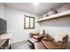Sitting area with shelving, two leather chairs and an ottoman, plus accent table and window at 11423 Atlantic Rd, Fortville, IN 46040