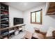 Sitting area with shelving, two leather chairs and an ottoman, plus accent table and window at 11423 Atlantic Rd, Fortville, IN 46040